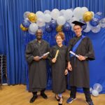 Pictured: Learners Lloyd Moodie, left, Sam Doyle and Lee Browning in their graduation caps and gowns